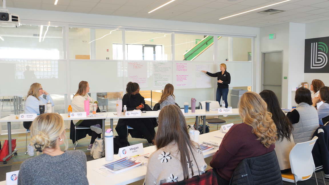 Woman taking a group photo on her iphone
