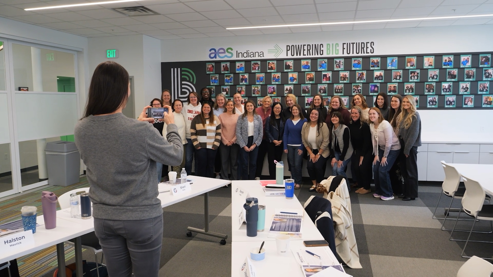Woman taking a group photo on her iphone